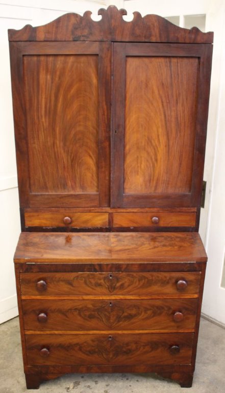 Hand-crafted, circa 1850's cabinet features hand-cut scroll, decorative top.